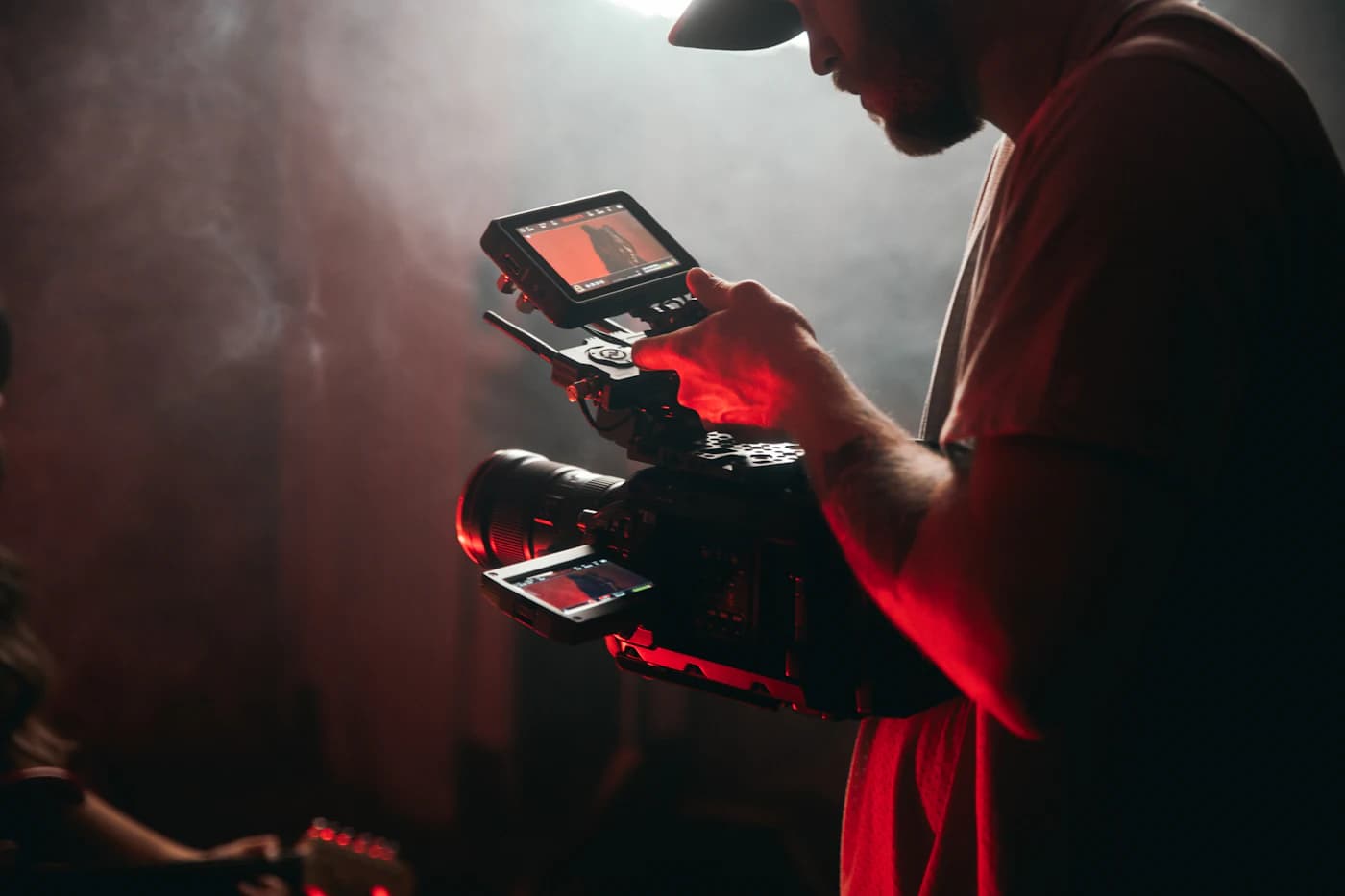 A creator holding a video camera on a shoot